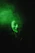 a man wearing a green mask in the dark