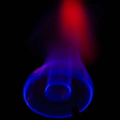 A sleek modern stove with glowing blue flames, showcasing innovative design.