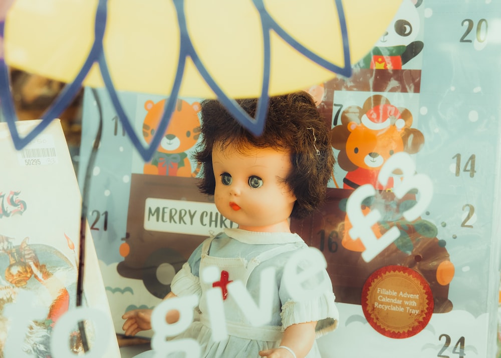 a doll with a red cross on it's shirt