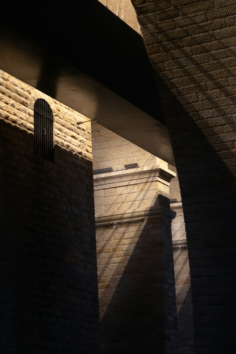 the shadow of a clock on a brick wall