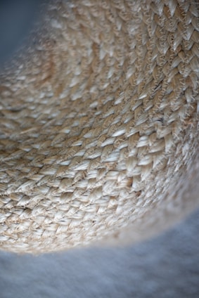 Close-up of artisan weaving natural fiber rug with detailed texture.