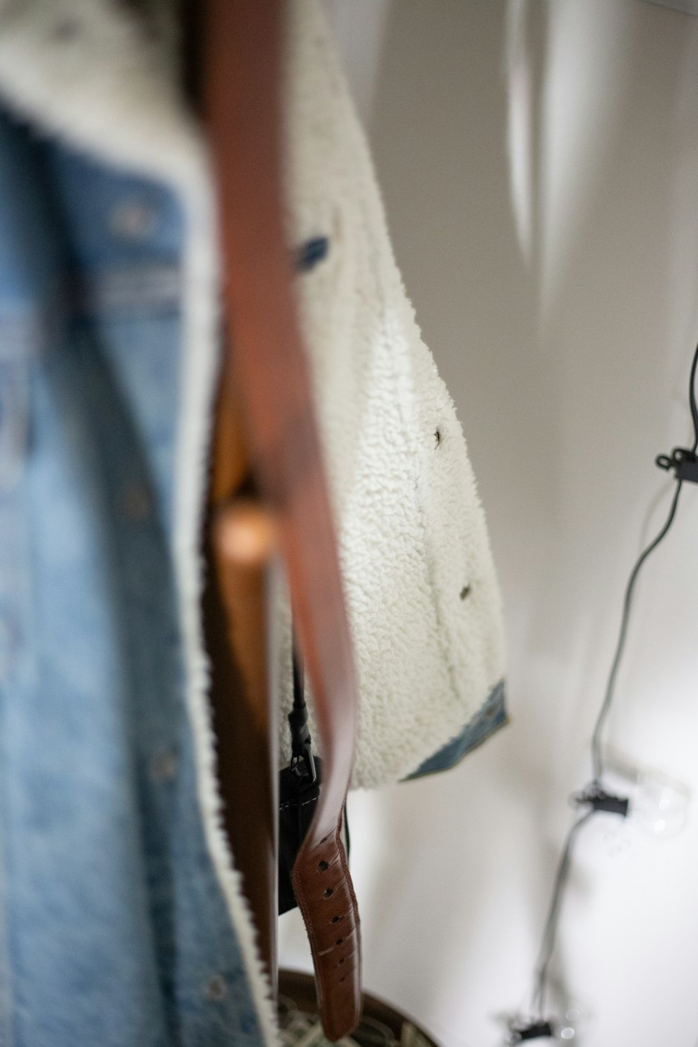 a pair of jeans hanging on a coat rack
