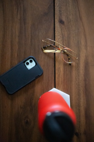 A stylish mobile phone holder displayed on a wooden table.