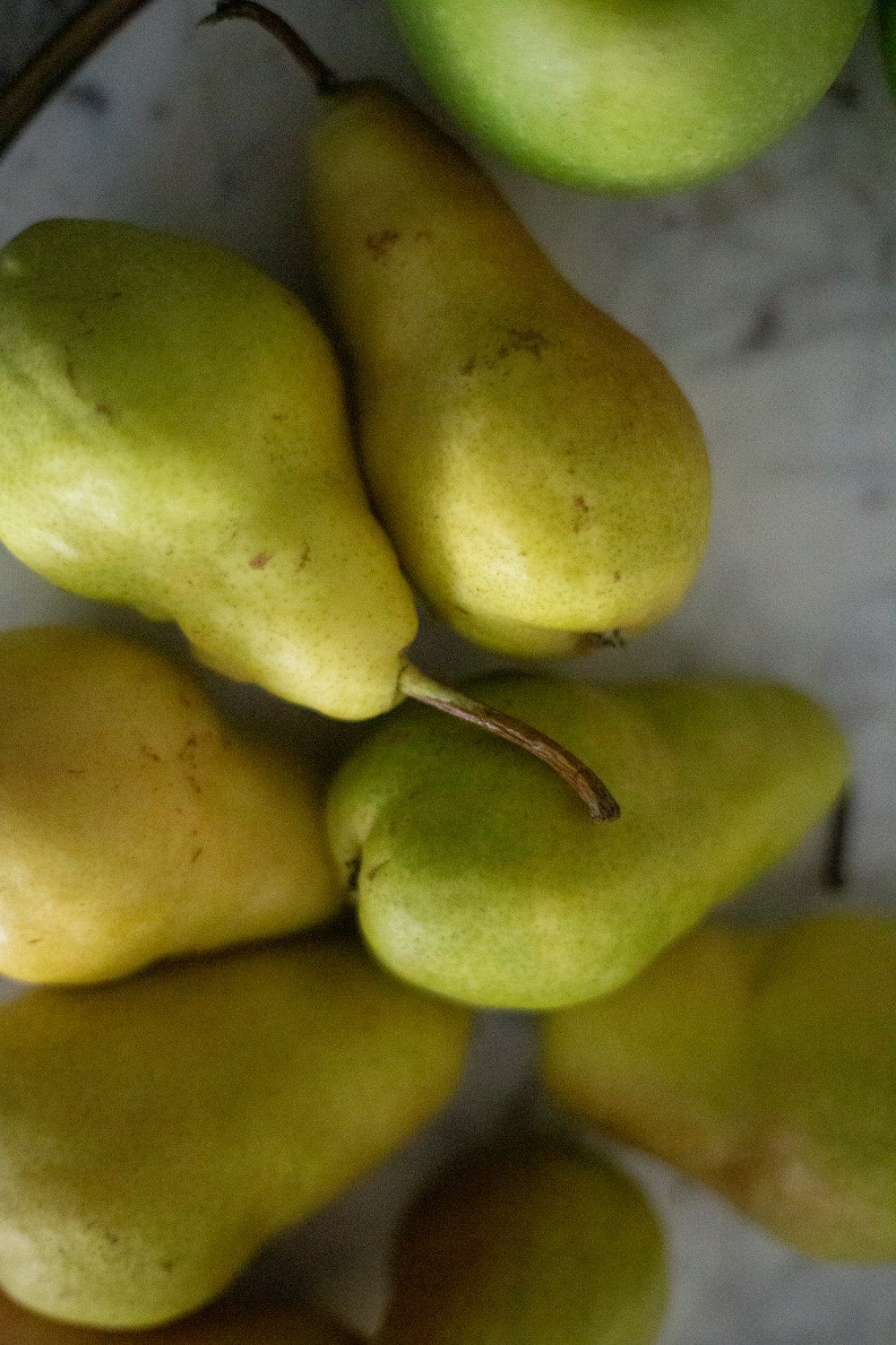 a pile of pears sitting on top of a table