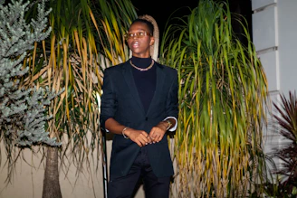 A warm portrait of Dalyon Shemil Benitez surrounded by books and botanical plants, symbolizing her blend of science and nurturing leadership.