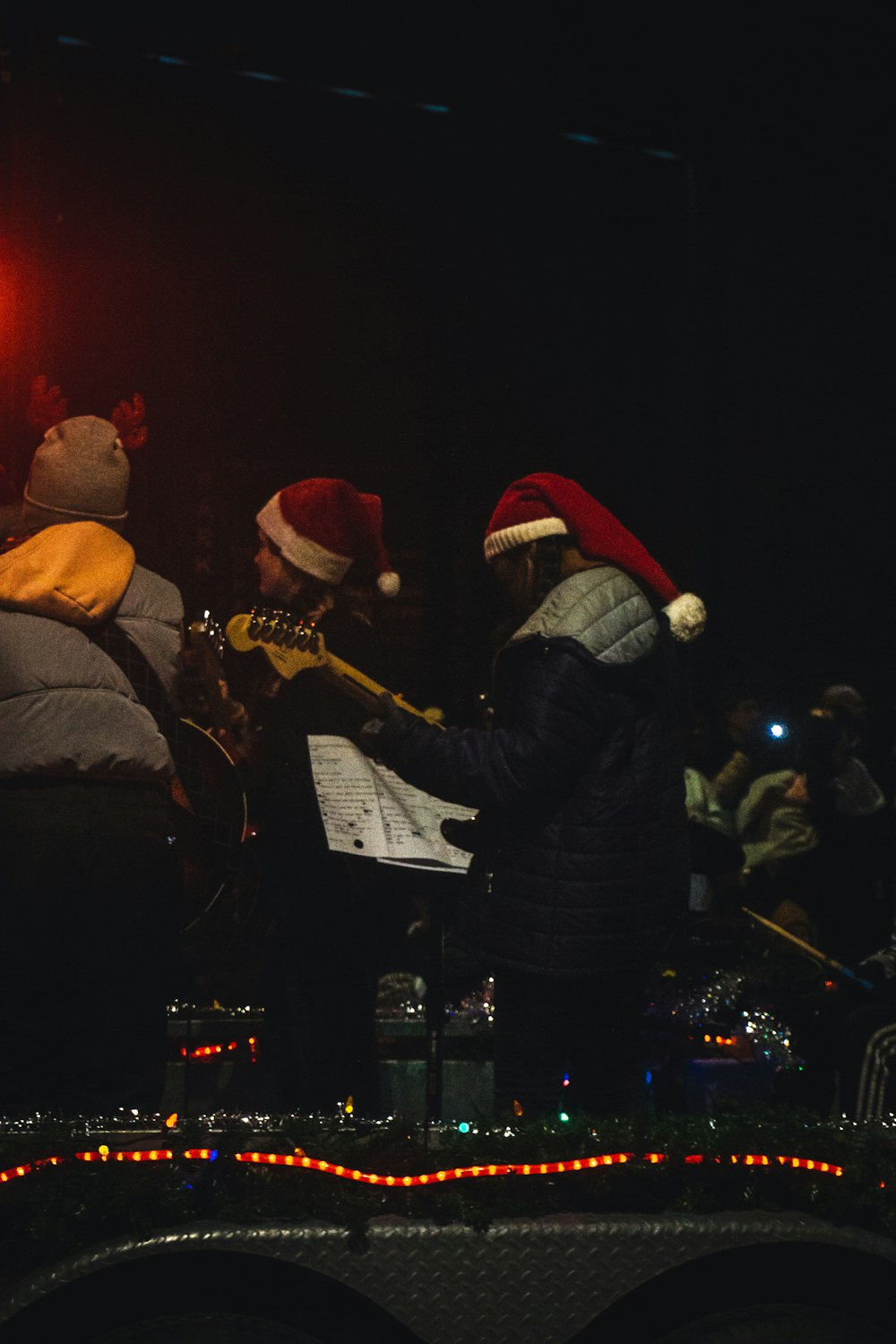 a group of people that are standing in the dark