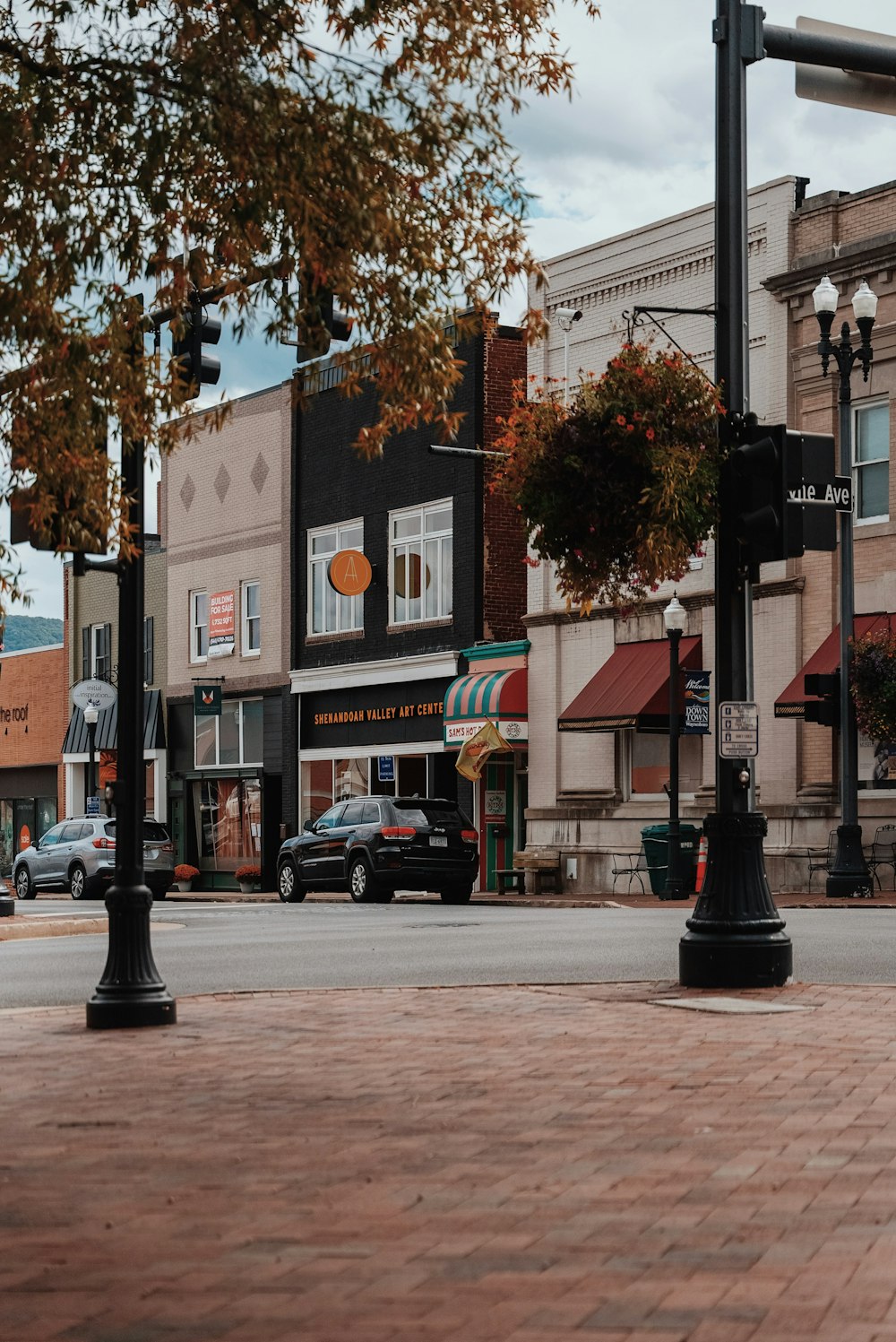 a city street with cars parked on the side of the road