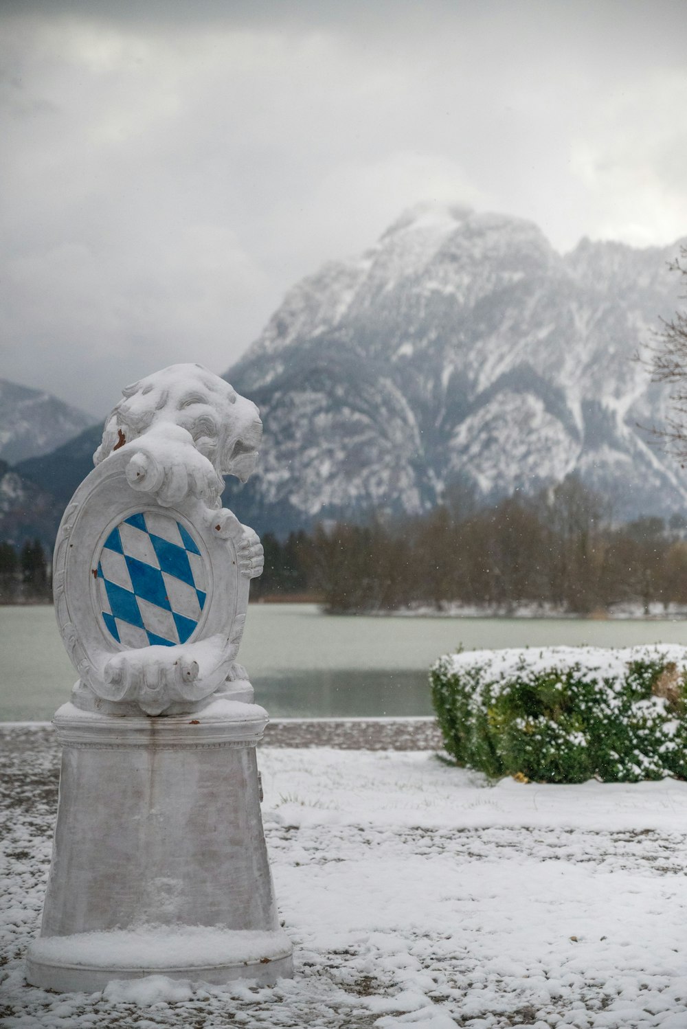 a statue of a coat of arms in the snow