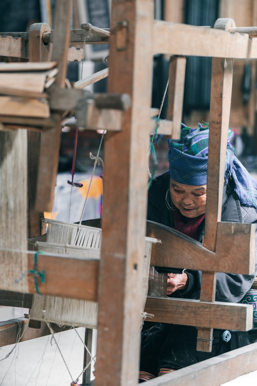 a woman is weaving fabric on a loom