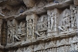 carvings on the side of a building in india