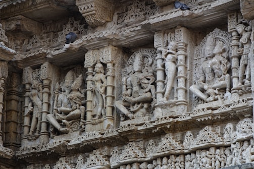 carvings on the side of a building in india