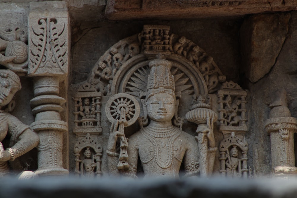 a close up of a statue on a building