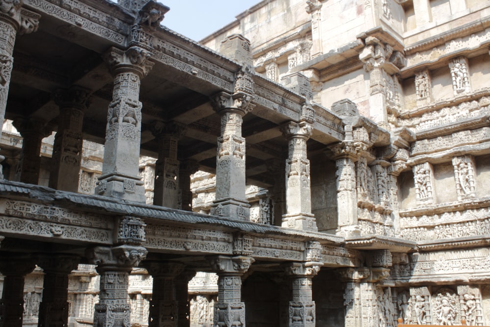 a group of stone pillars in front of a building