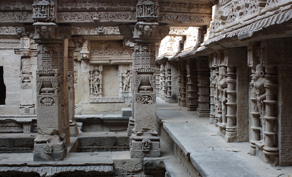 a row of stone pillars with carvings on them