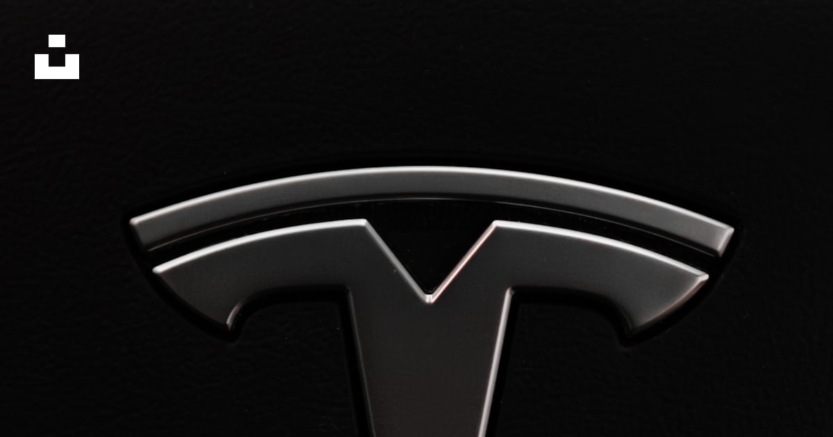A close up of a tesla logo on a car photo – Free Logo Image on Unsplash