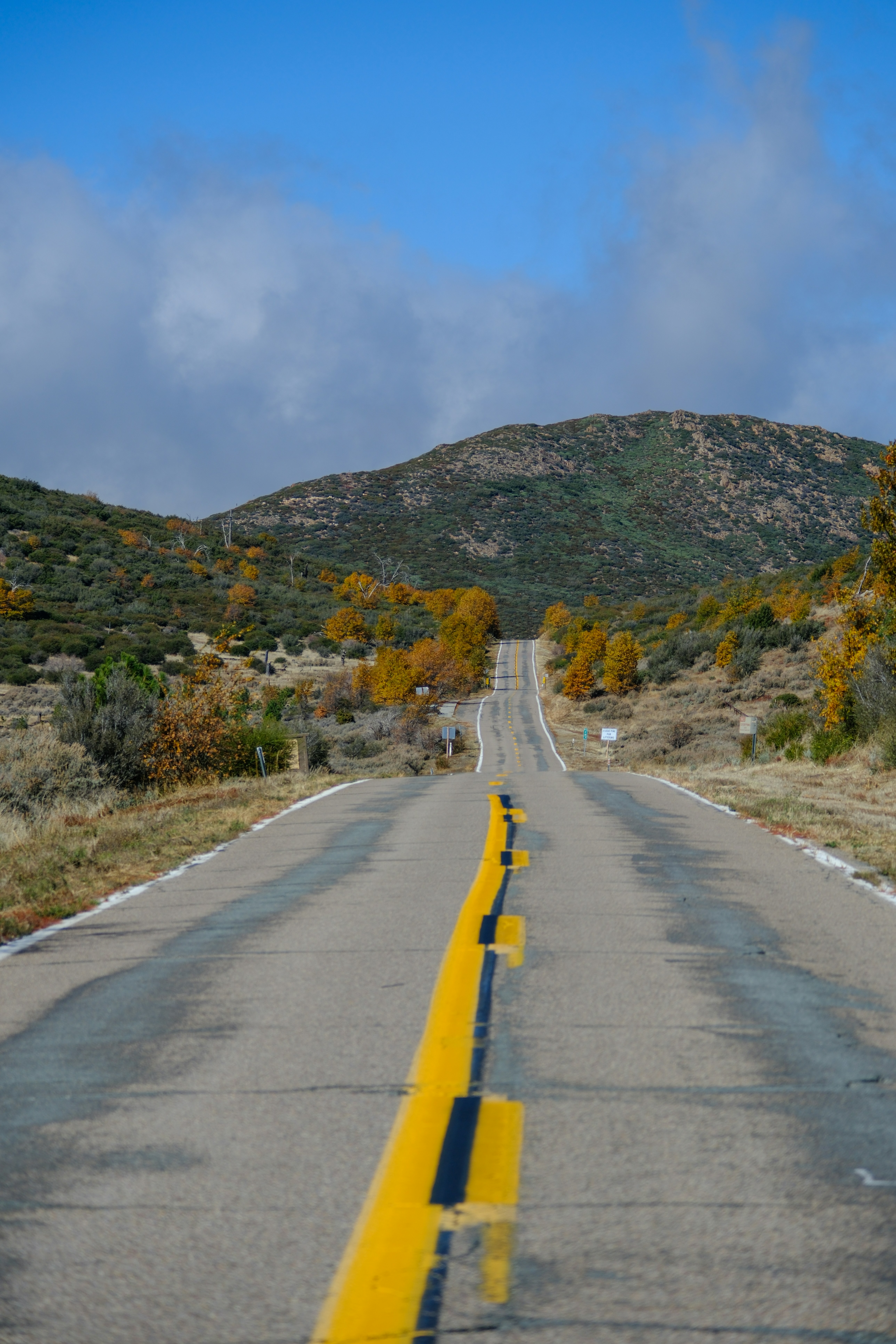 a road with a yellow line on the side of it
