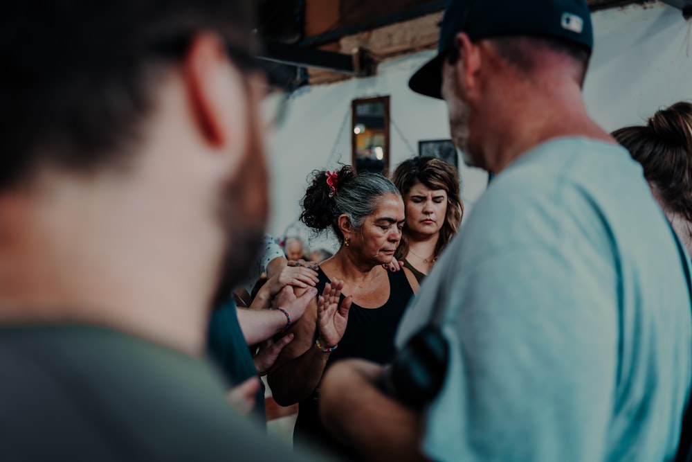 a group of people standing around each other