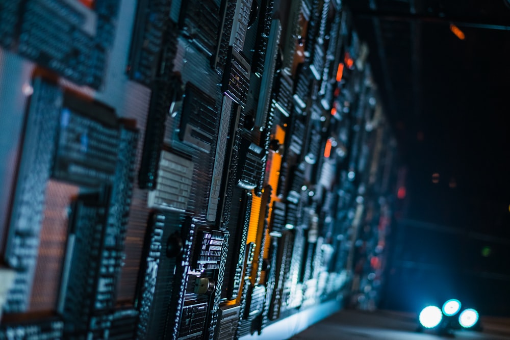 a wall of electronic equipment in a dark room
