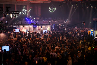 A vibrant global business conference with diverse entrepreneurs networking and exchanging ideas under bright lights.
