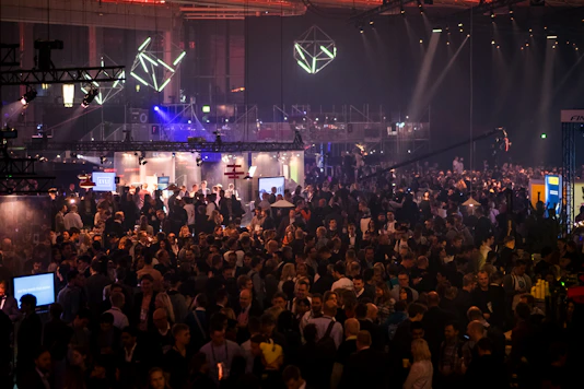 A vibrant global business conference with diverse entrepreneurs networking and exchanging ideas under bright lights.