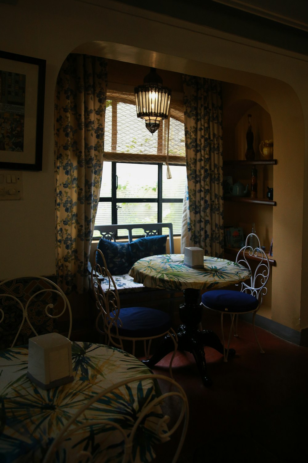 a table and chairs in a room with a window