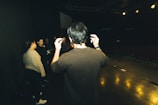 Close-up of an actor rehearsing a dramatic scene on stage.