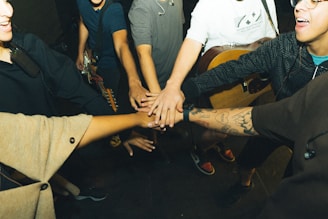 a group of people holding hands in a circle
