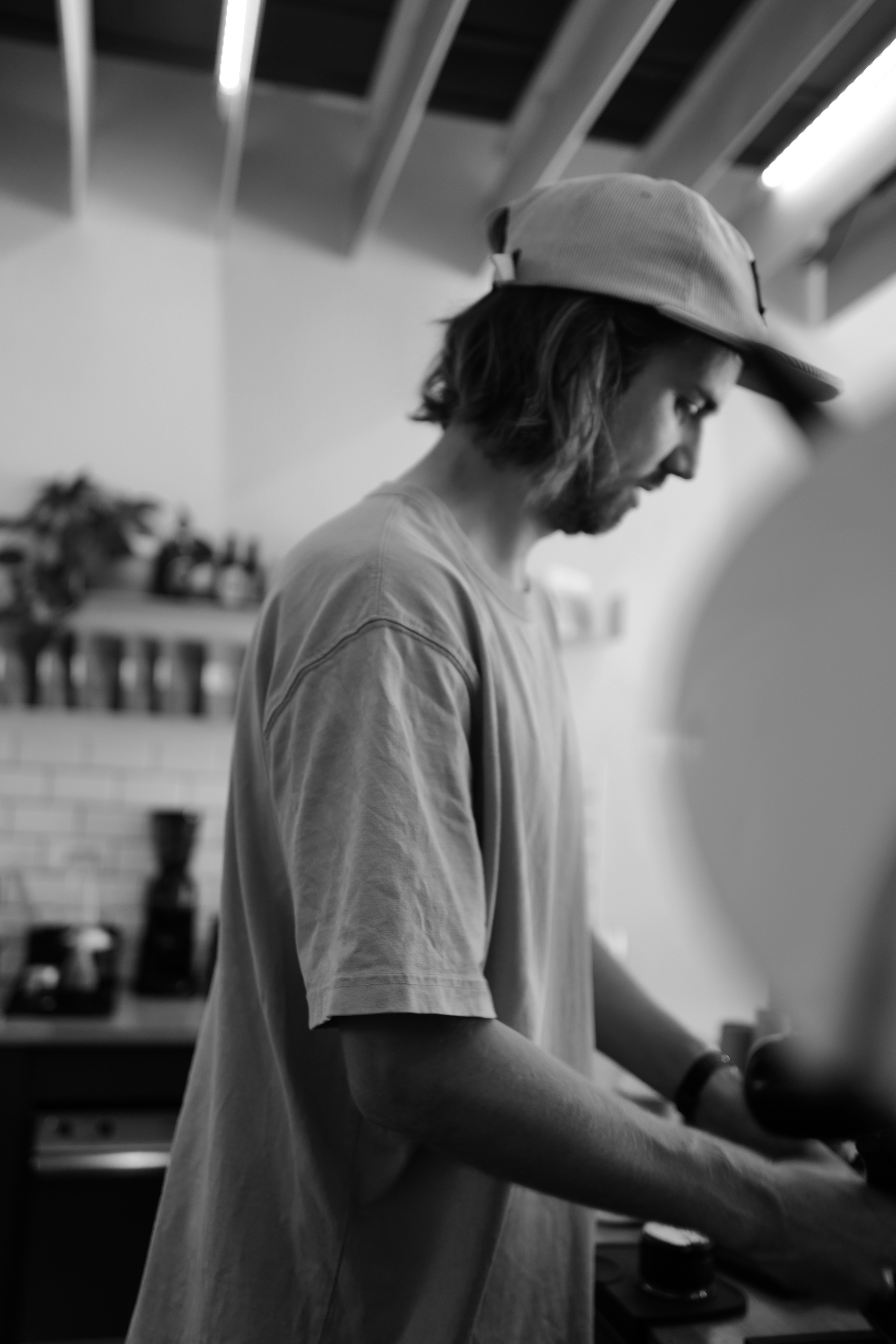 a man in a hat is preparing food in a kitchen