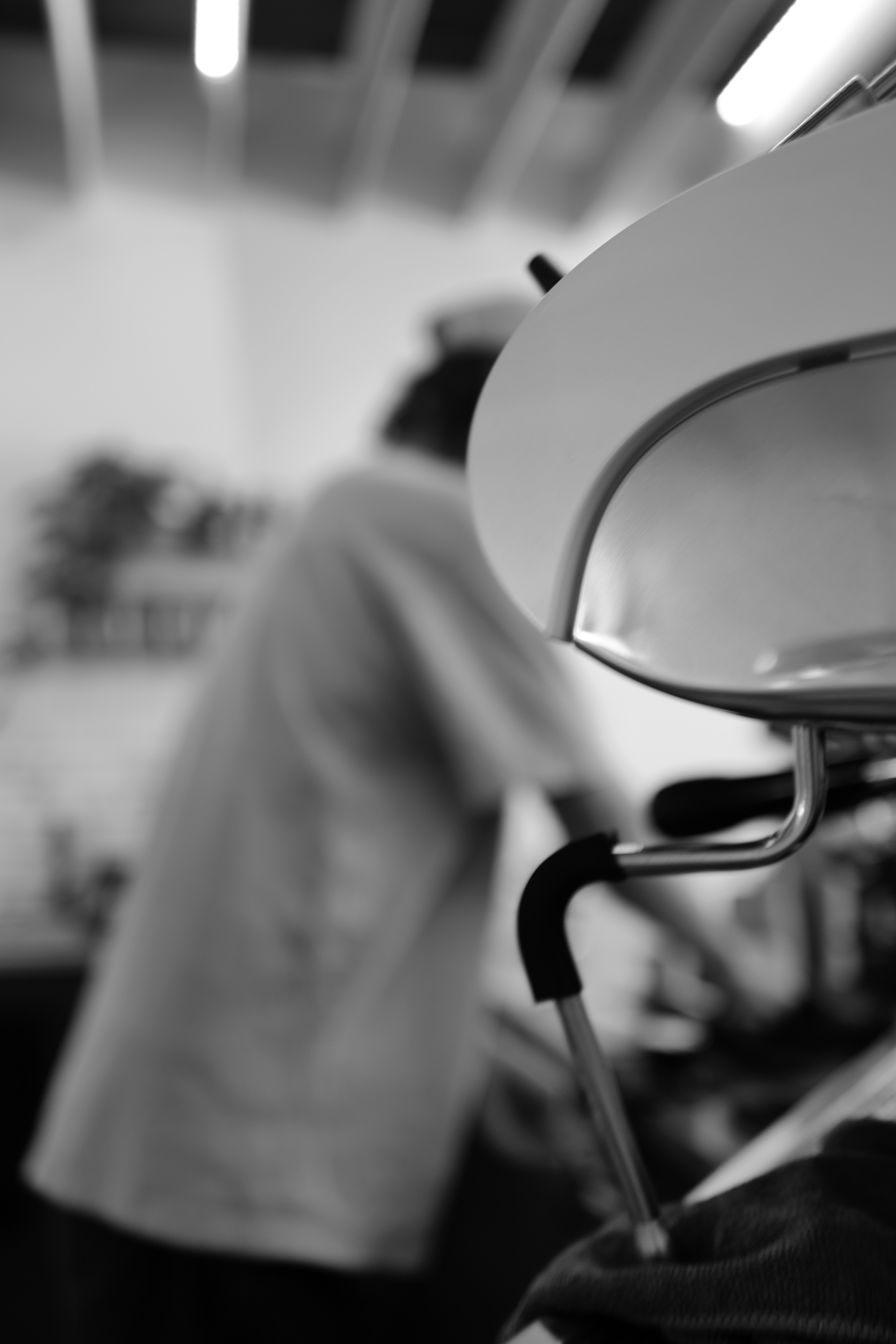 a black and white photo of a person in a kitchen
