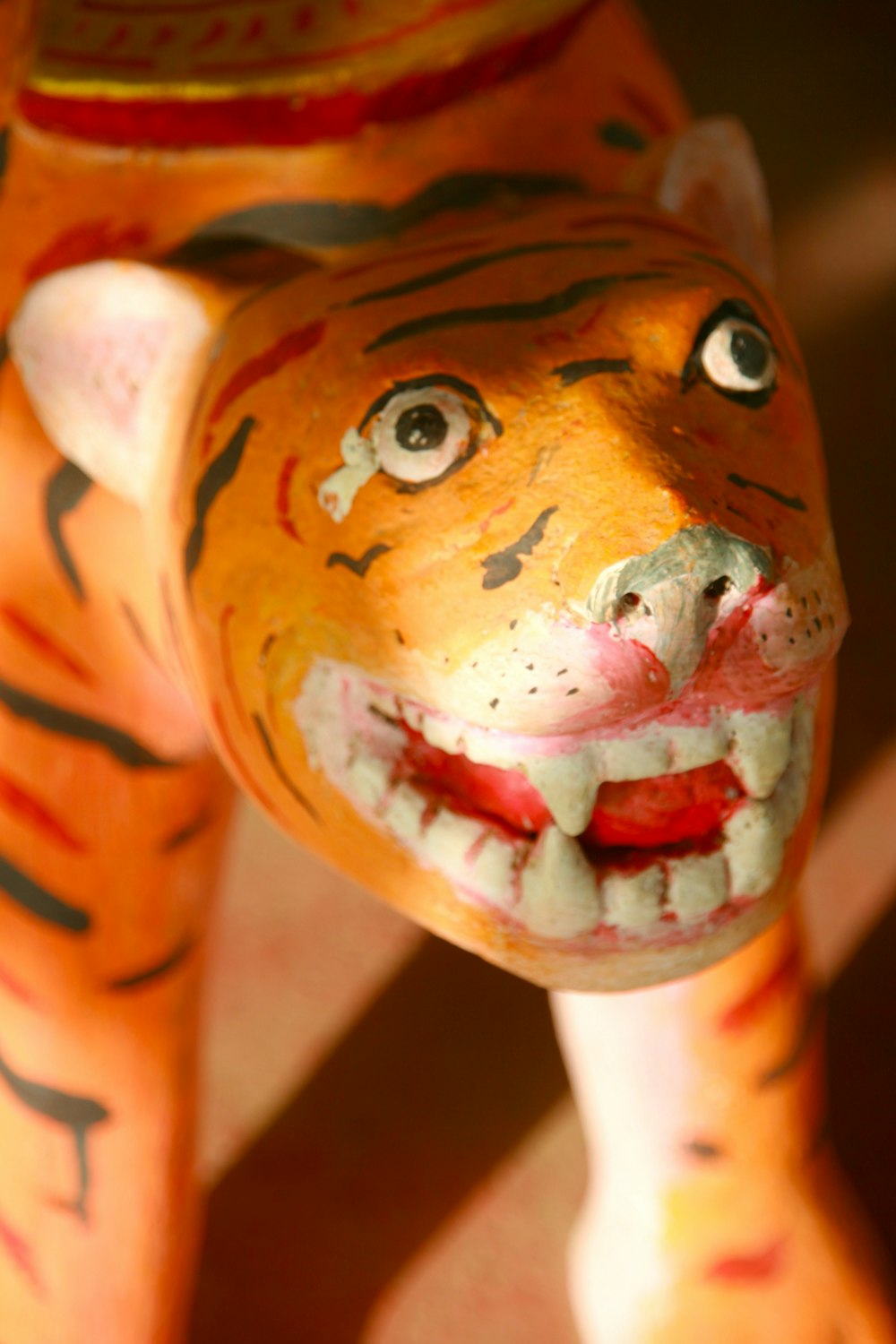 a close up of a tiger statue on a tile floor