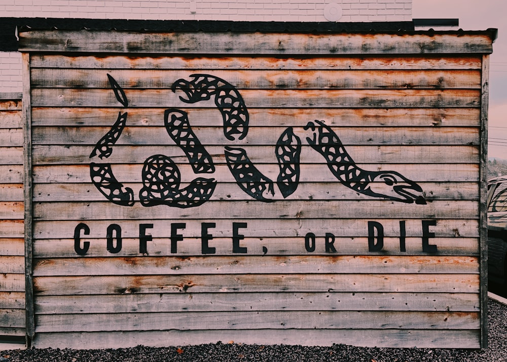 a sign on the side of a building that says coffee or die