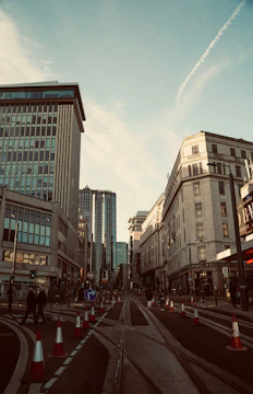 A city street with workers inspecting infrastructure under clear skies.