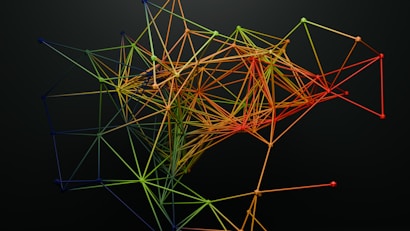 A complex, abstract structure composed of interconnected lines and nodes, forming a colorful network on a dark background. The lines are primarily shades of green, yellow, orange, and red, creating a gradient effect across the structure.