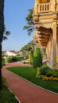 The elegant clubhouse building surrounded by landscaped gardens and walking paths.