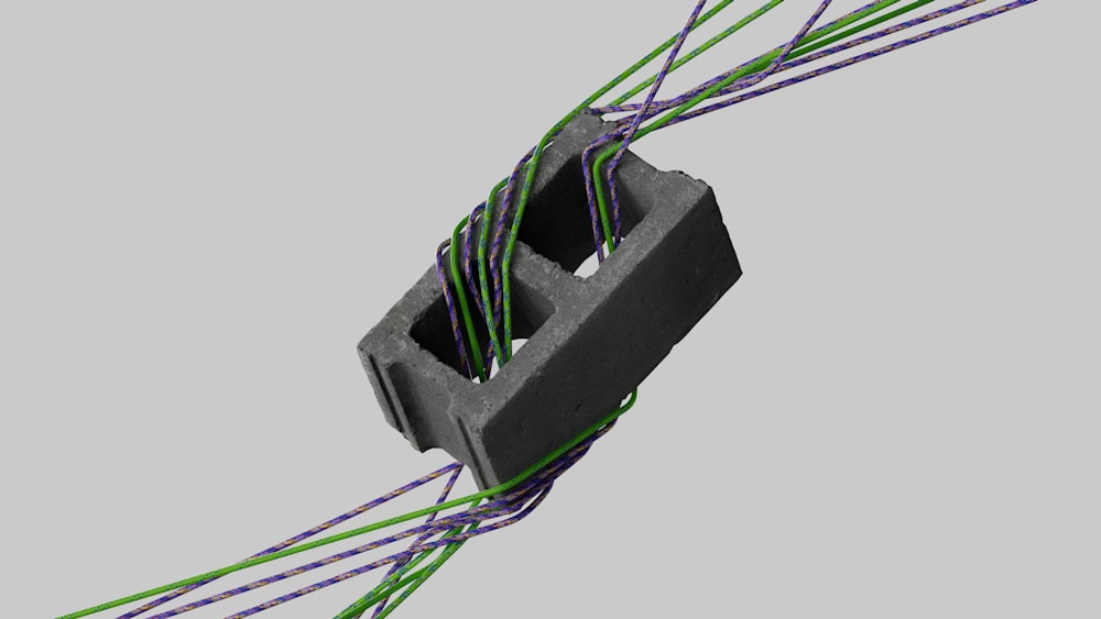 a close up of a wire with green and purple wires