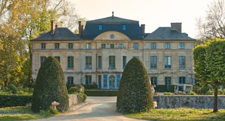 a large building with a lot of trees in front of it