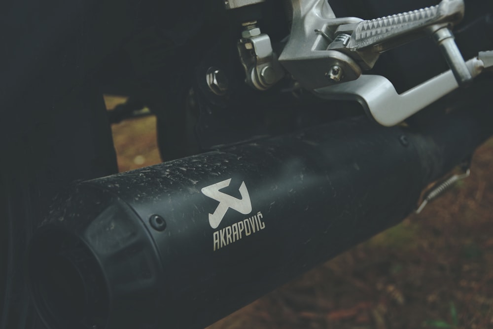 a close up of a bike handlebar with a logo on it