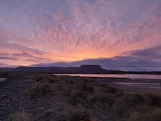 A breathtaking landscape showcasing a serene beach at sunset.