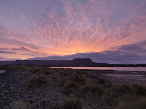 A breathtaking landscape showcasing a serene beach at sunset.