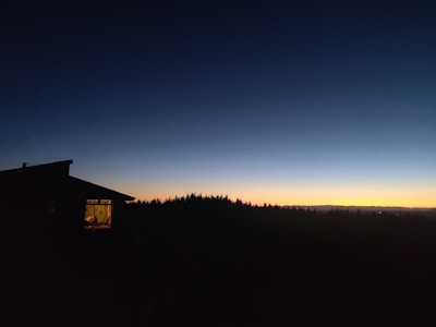 Evening shot of home glowing warmly against a twilight sky.