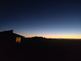 Evening shot of home glowing warmly against a twilight sky.