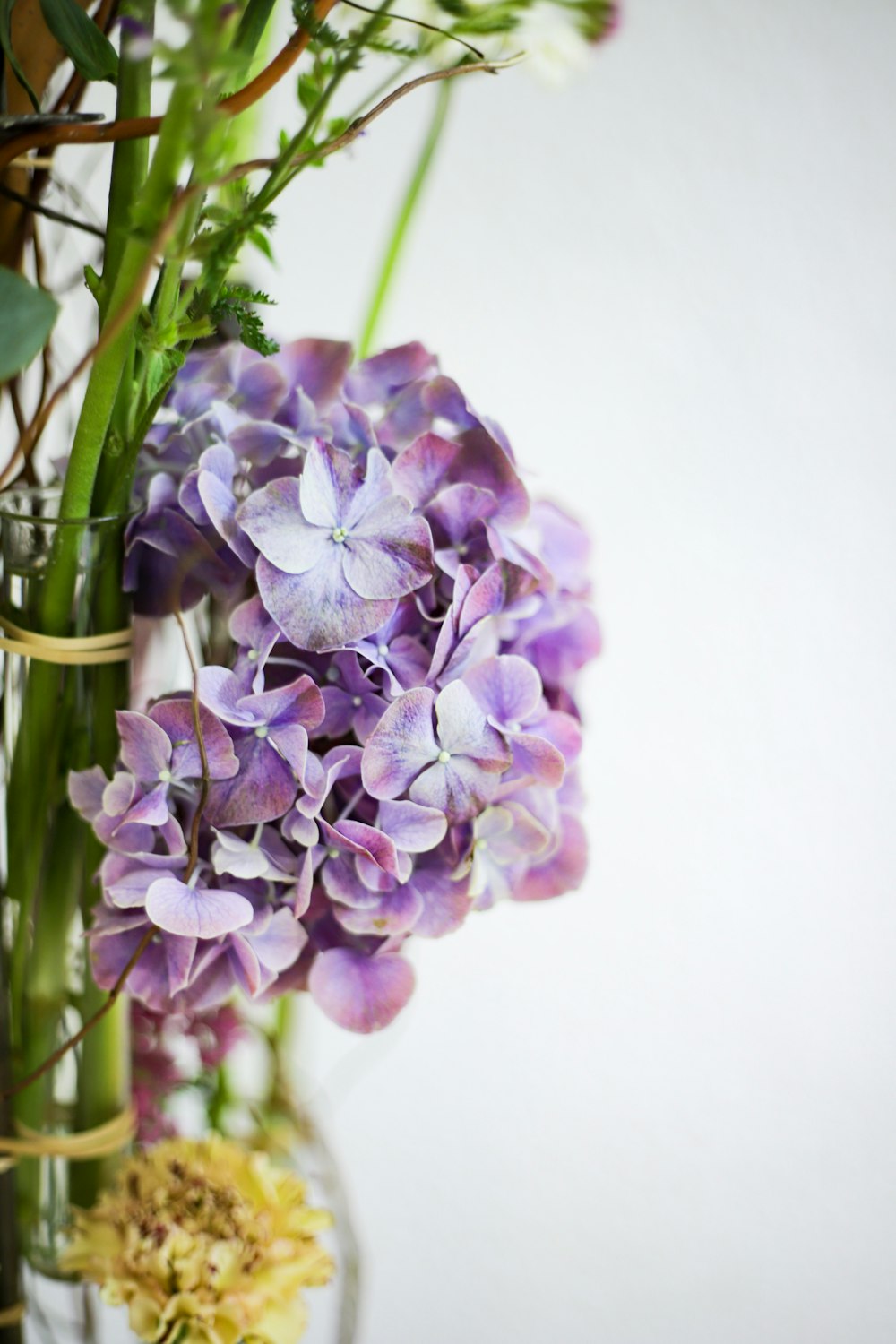 a vase filled with purple and white flowers