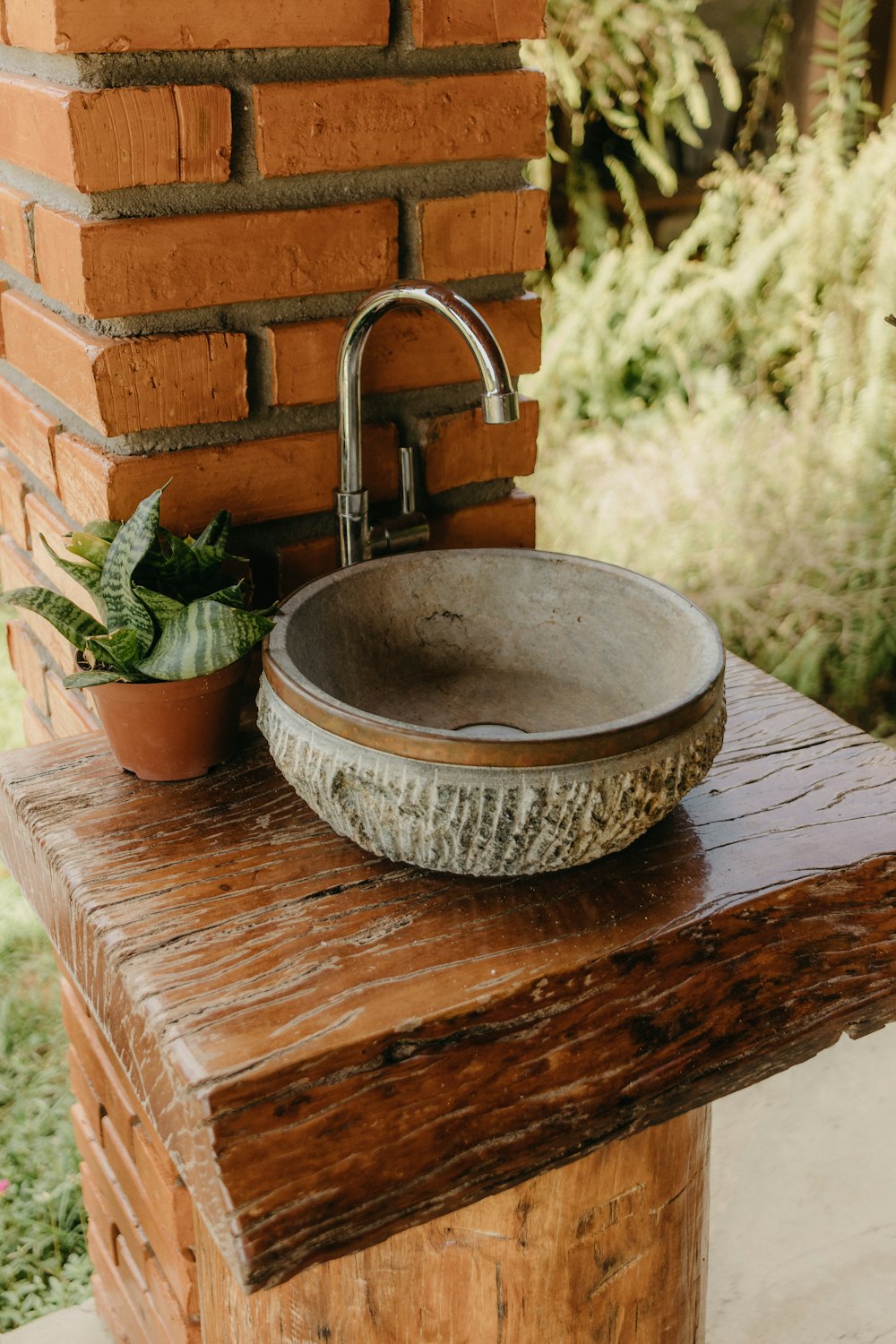 a sink sitting on top of a wooden table