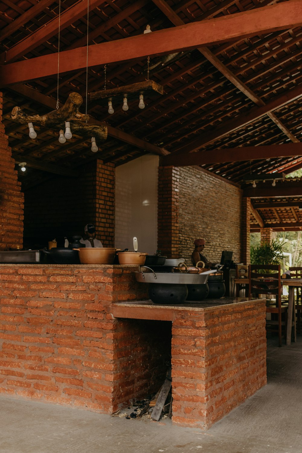 a kitchen with a brick wall and a grill