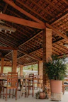 Outdoor seating area with rustic wooden furniture surrounded by Mediterranean plants.