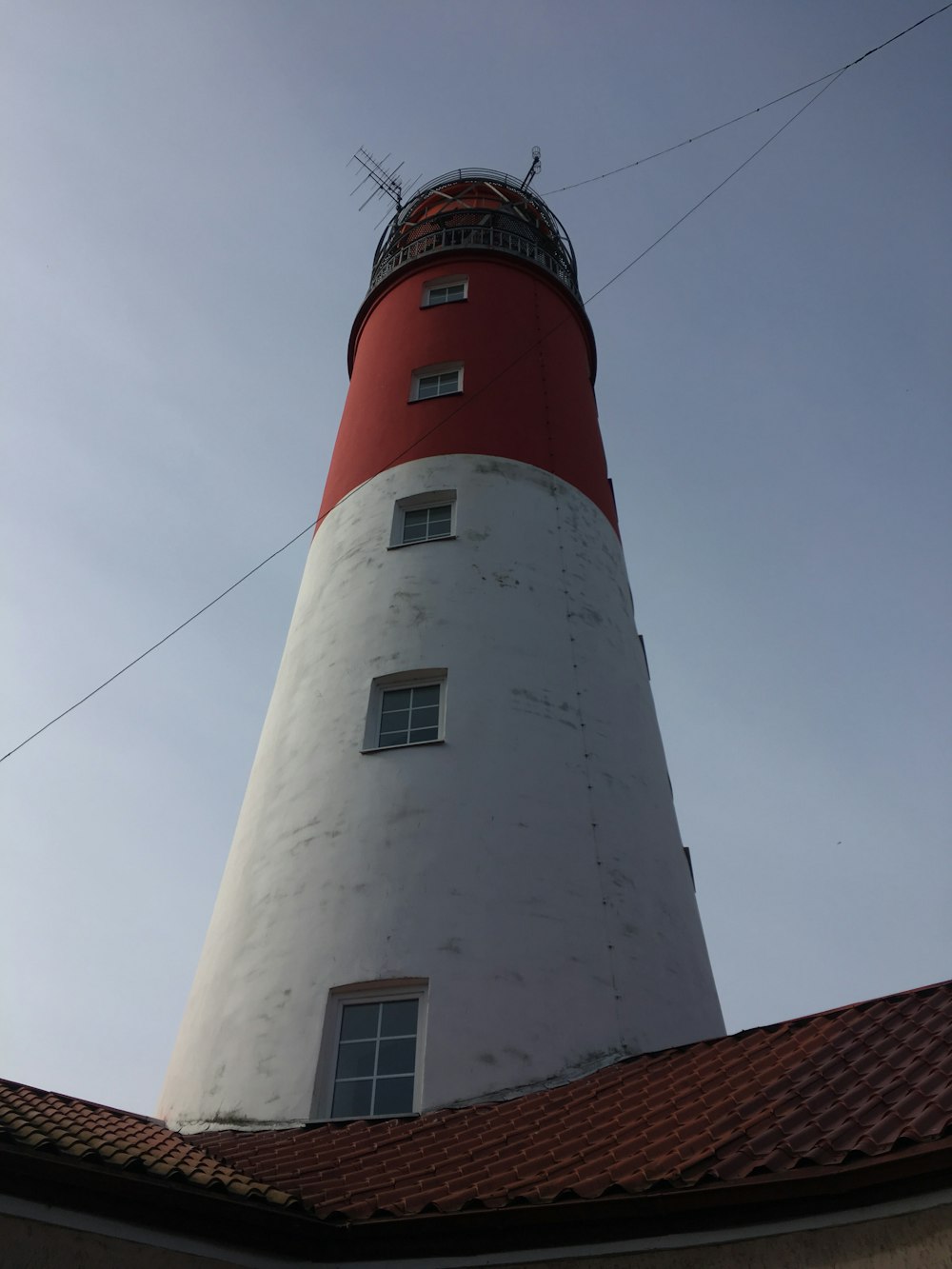 a red and white lighthouse on top of a building