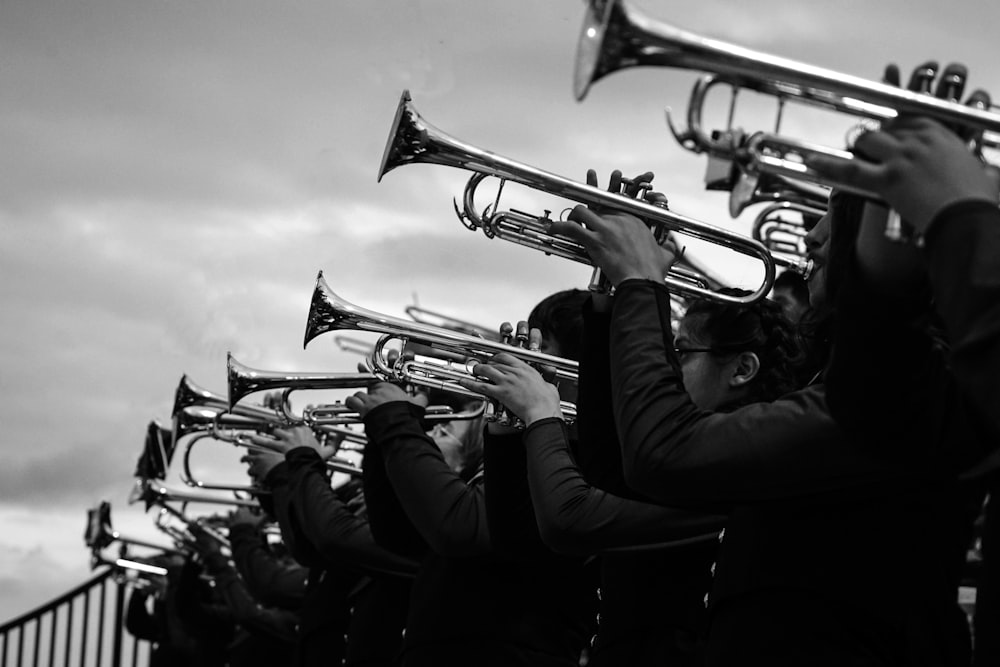 a black and white photo of a group of people playing musical instruments
