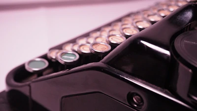 Close-up of a vintage typewriter with cream and charcoal tones, evoking classified dossiers.