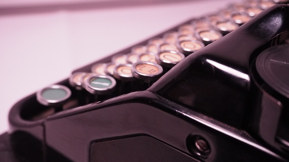 a close up of a black typewriter with lots of buttons