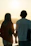 A serene photo of a couple holding hands at sunset on a quiet beach.